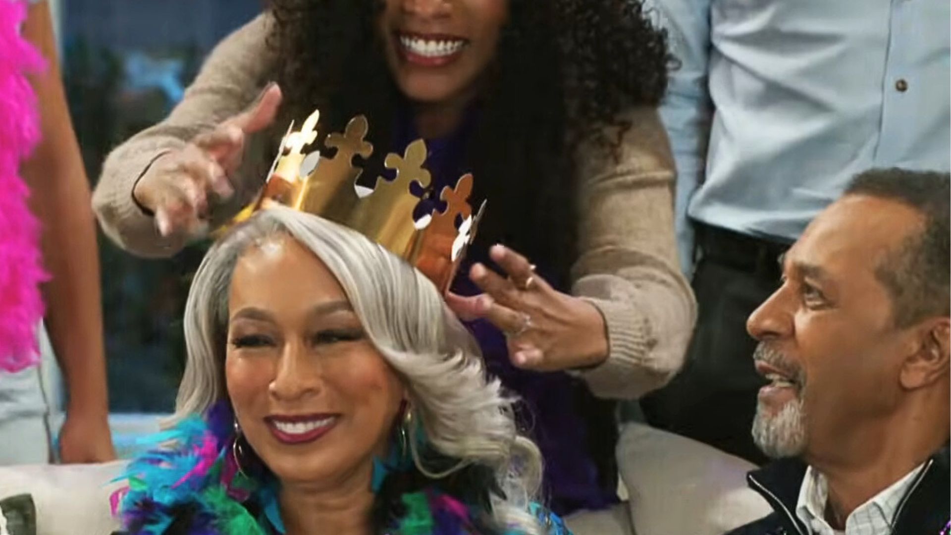 Naomi crowns a smiling Anita for Mardi Gras as Vernon watches on Beyond the Gates 