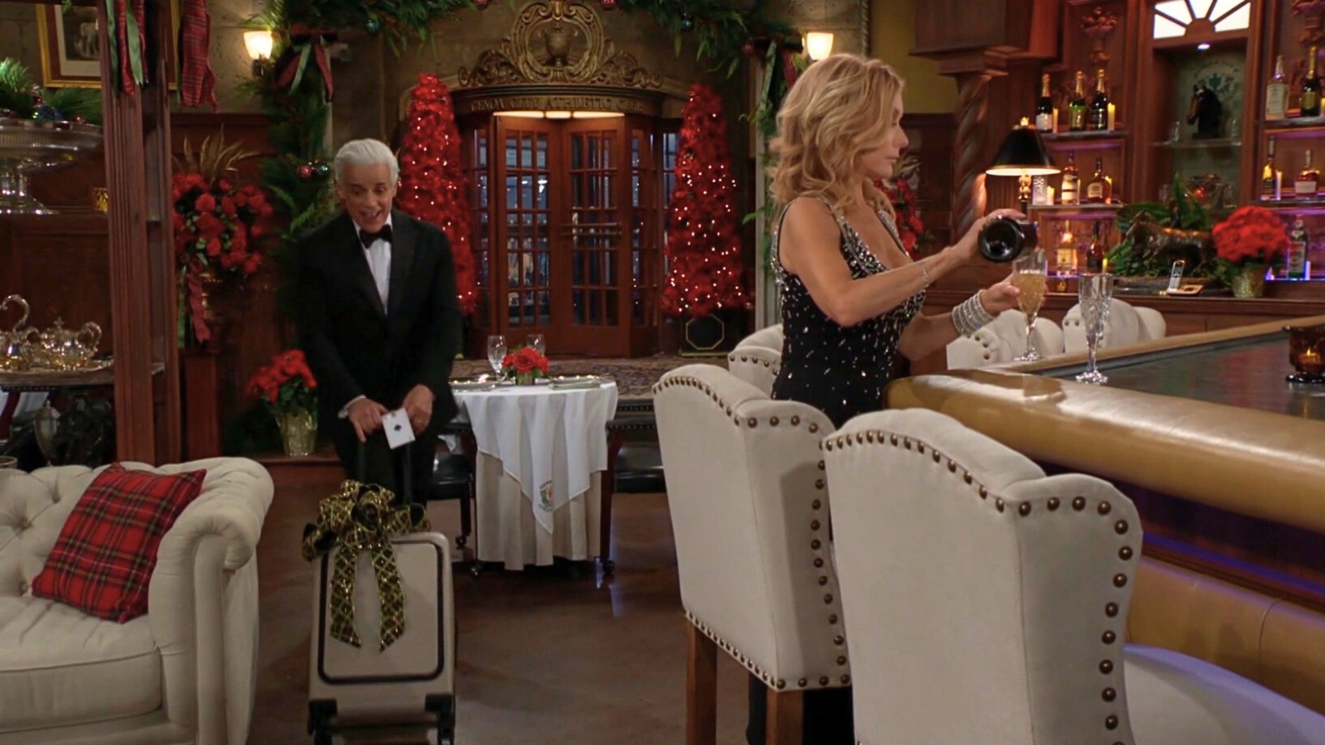 Michael with a suitcase and Lauren pouring a drink on The Young and the Restless recap